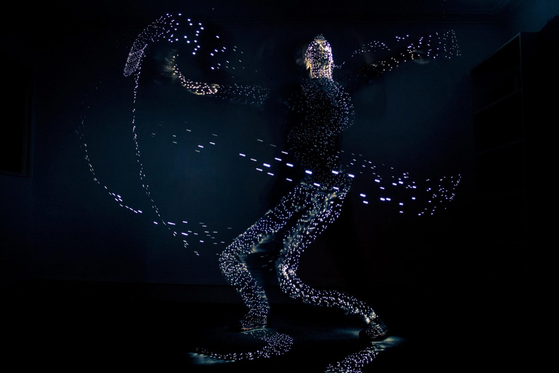 Long exposure photo of a person painting himslef with a lightbrush